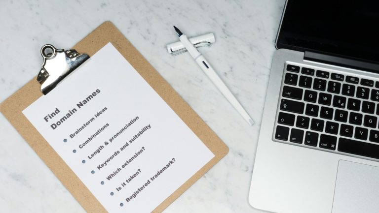 white printer paper beside silver macbook