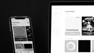 a laptop computer sitting on top of a wooden desk